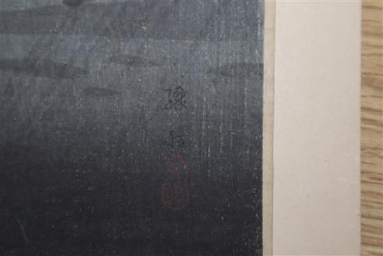 Japanese School, pair of woodblock prints, Travellers in stormy weather, 38 x 17cm, unframed